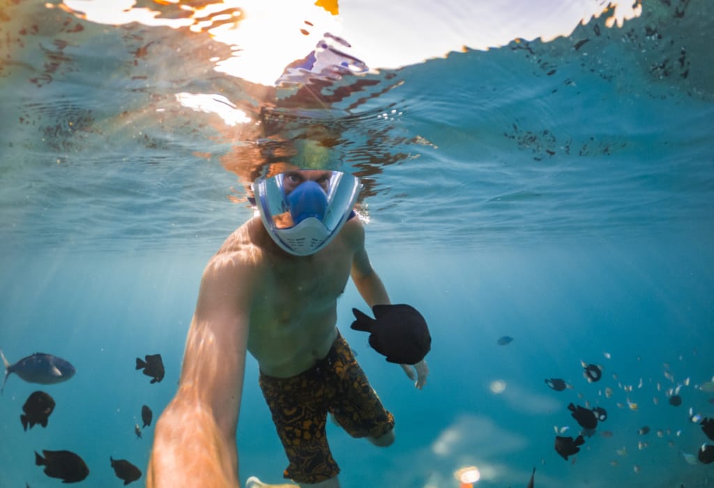 snorkeling-near-a-tropical-island-young-man-swims-in-the-water-sea-vacation-1