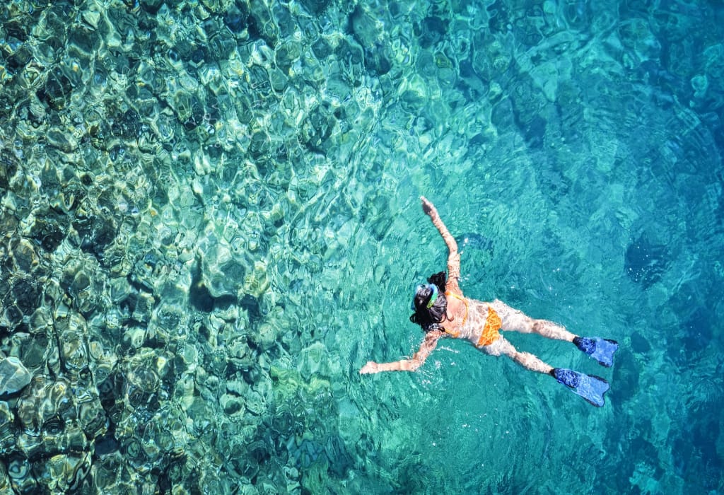 woman-snorkeling-in-tropical-sea-water